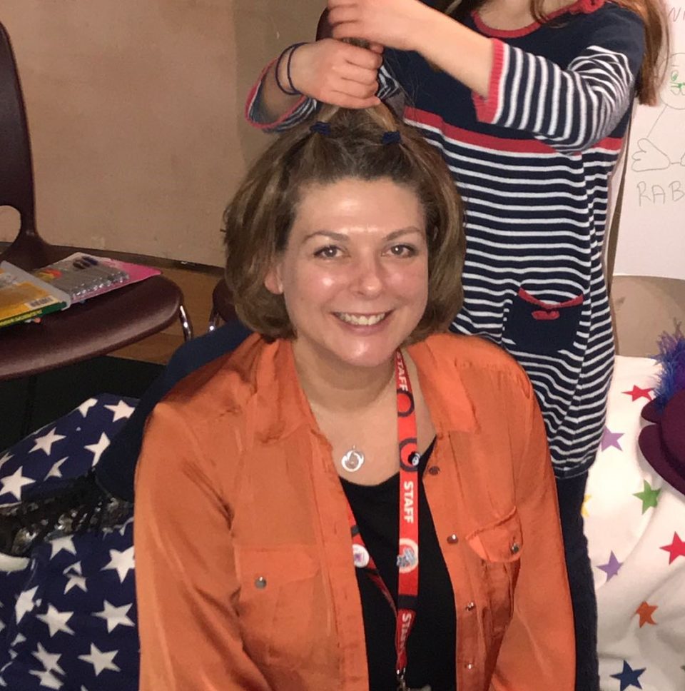 Tanya sitting with one of the children during a story telling session