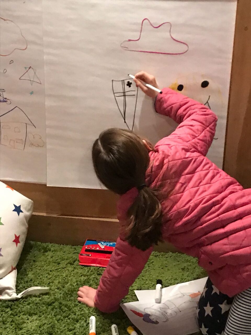 A child drawing a picture of a shield